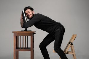 40507055 - funny and crazy man using a computer on gray background